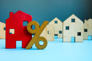 How Much Do Property Managers Charge? Sometimes it is percentage based. Red house model and percent sign.