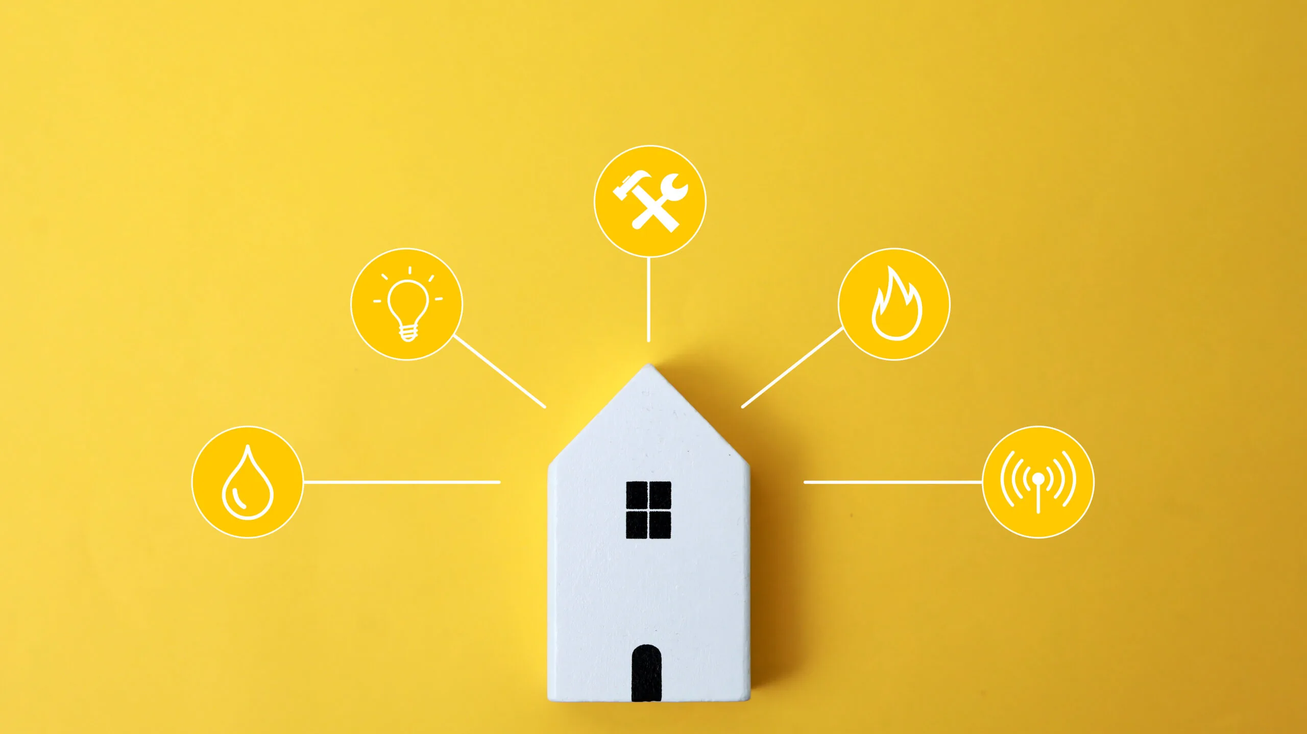 miniature house and pictures of utilities, heat, electricity, internet, water