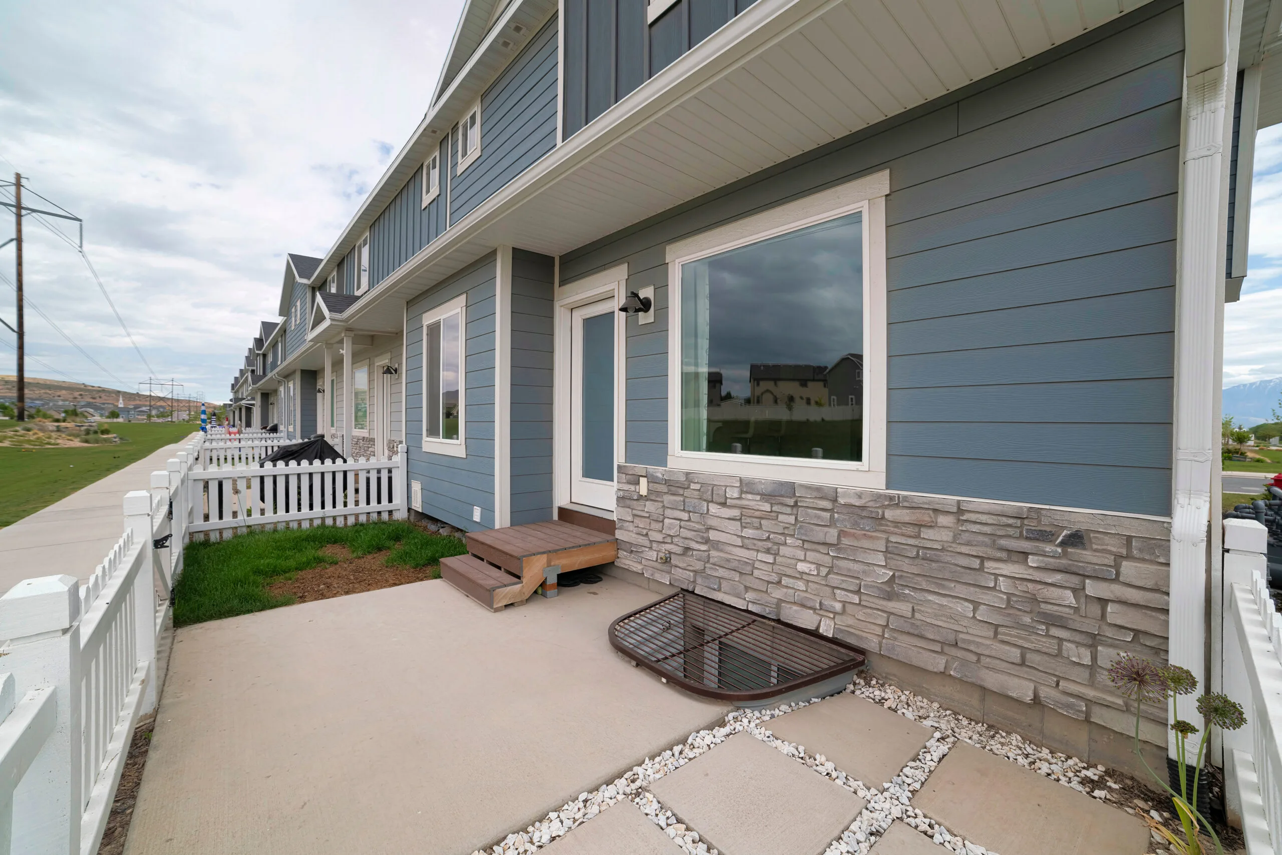 Exterior of a townhouse with bricks and wooden siding 