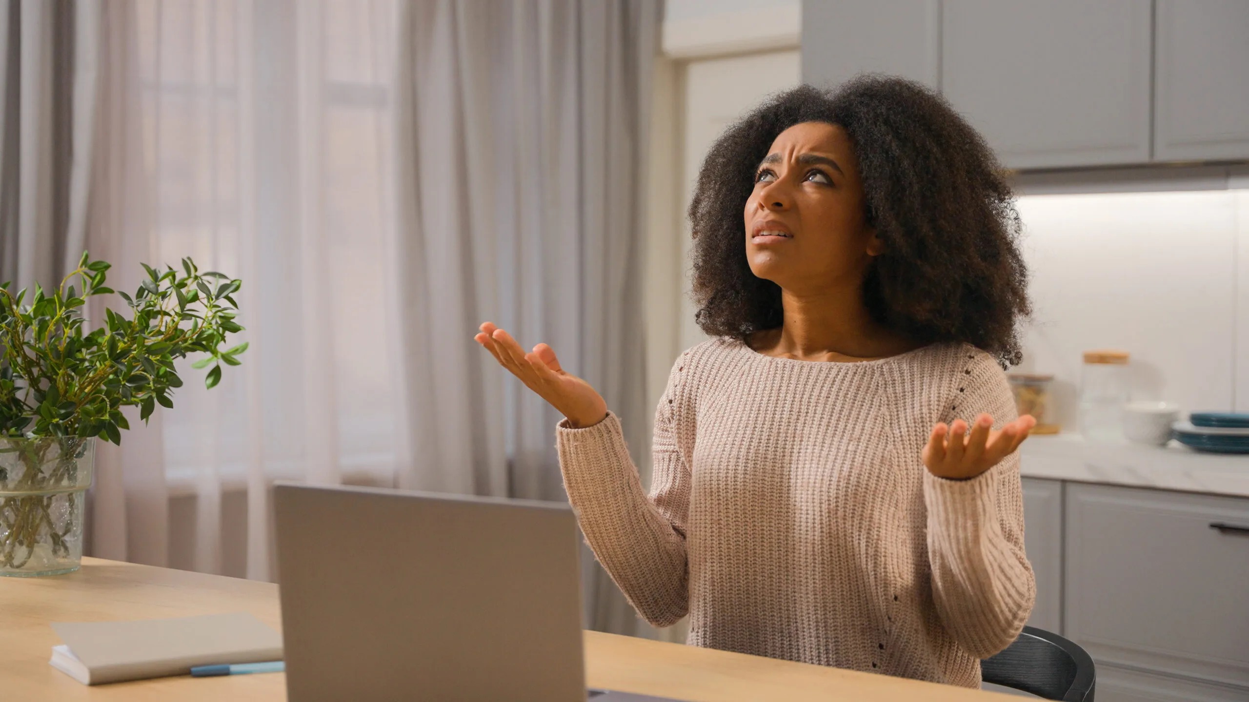 woman looks at the ceiling, stressed by the noise upstairs