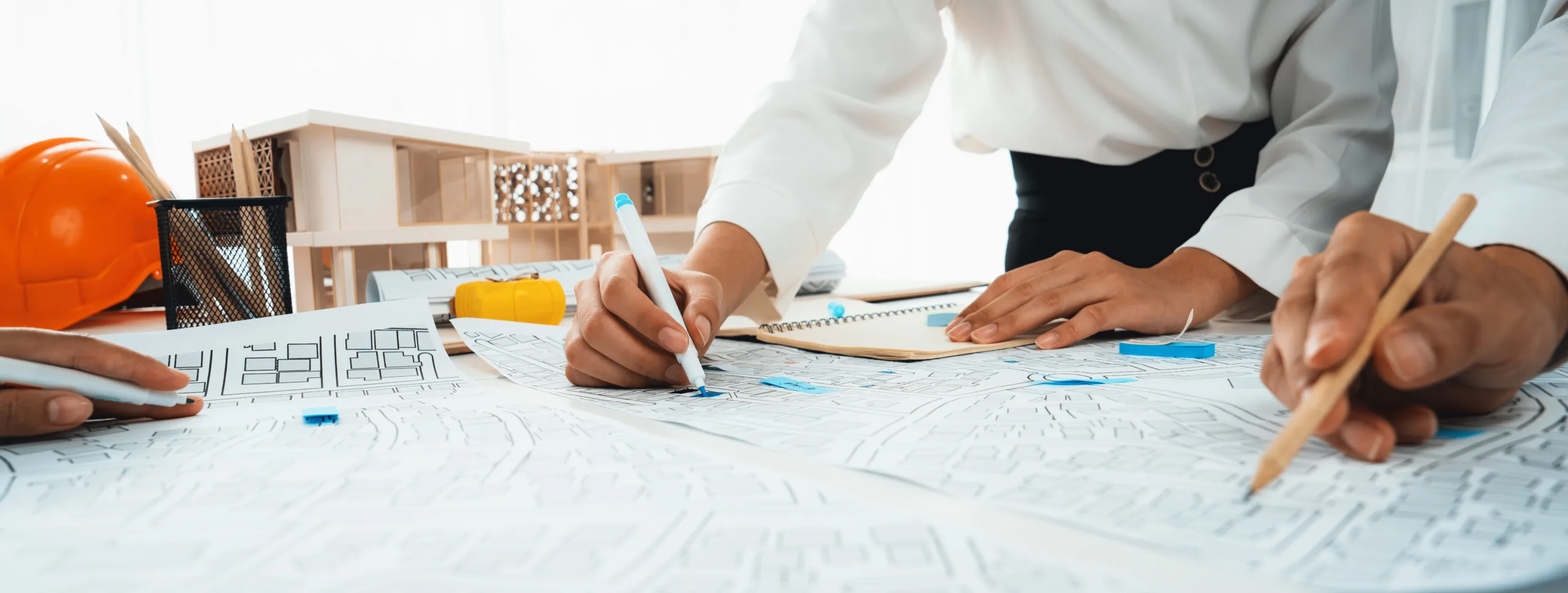 three people drawing maps