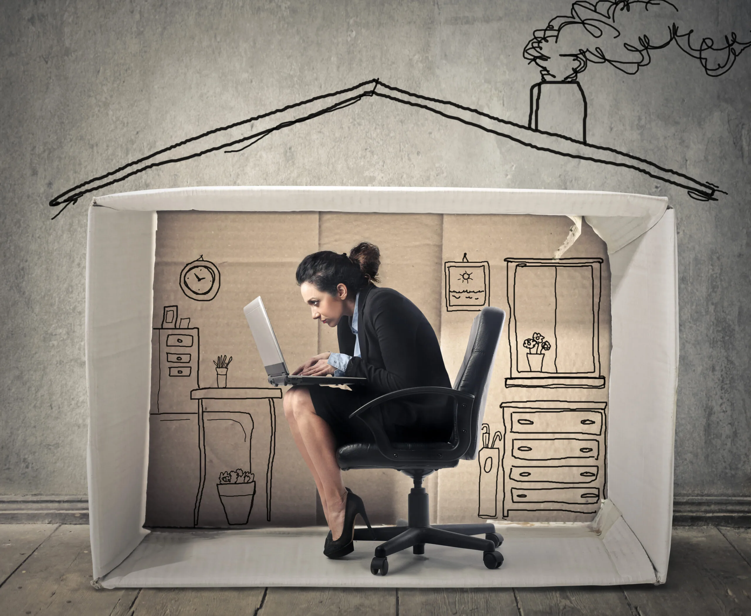 woman huddled in home with laptop