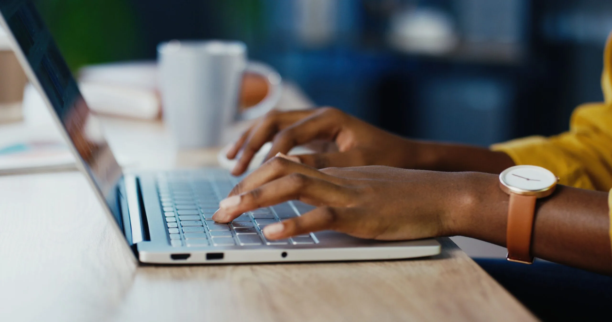 hands on laptop keyboard