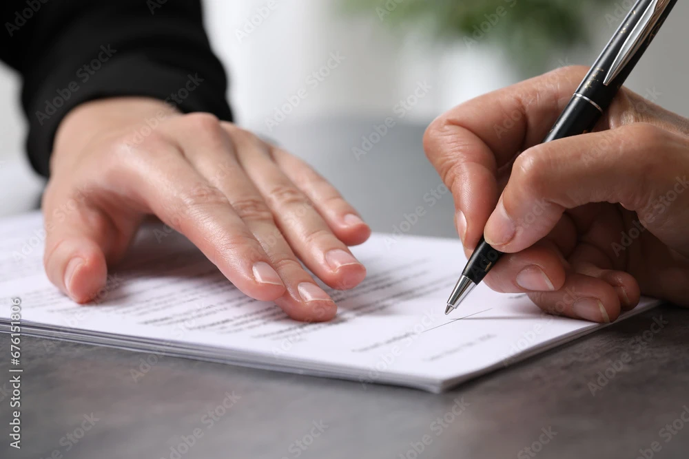 someone signing a paper