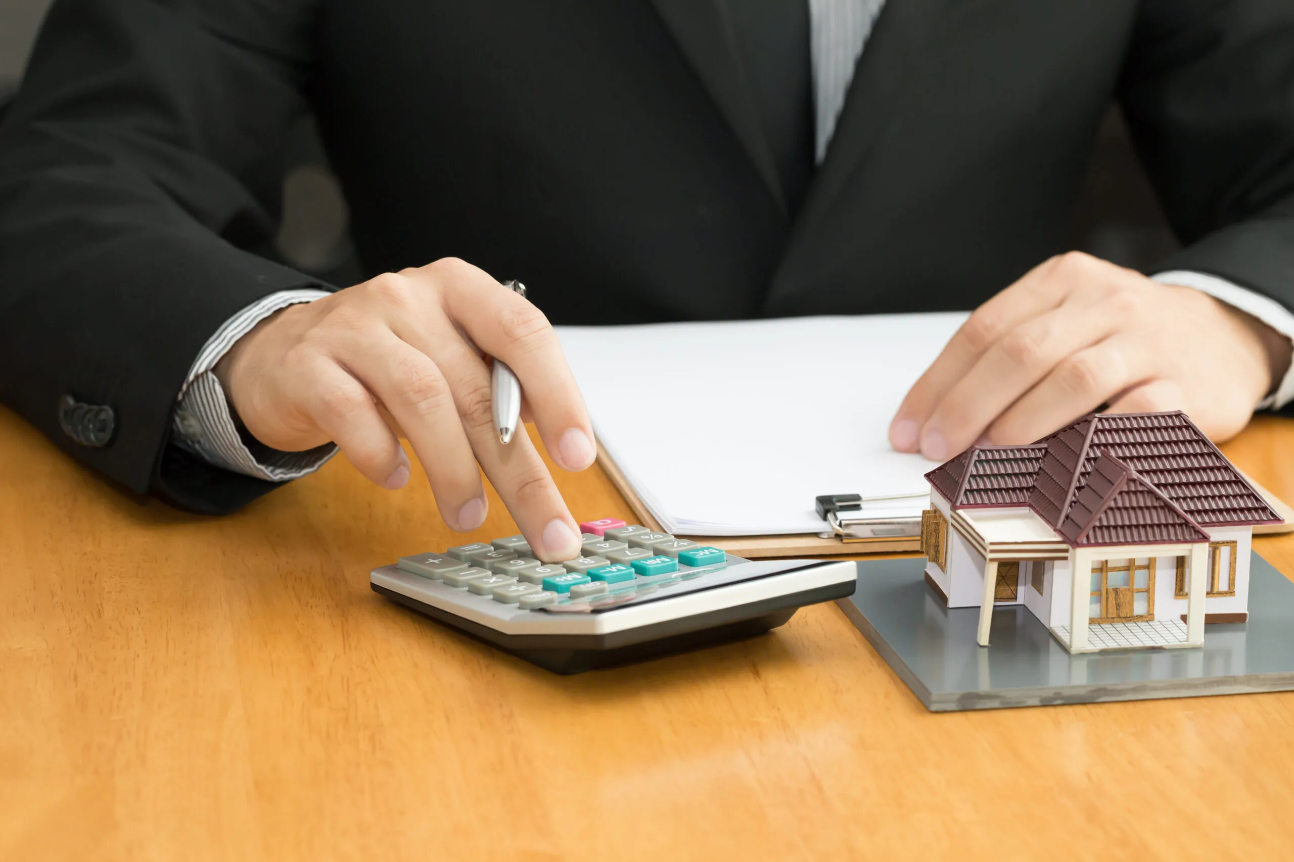 man with hands on calculator