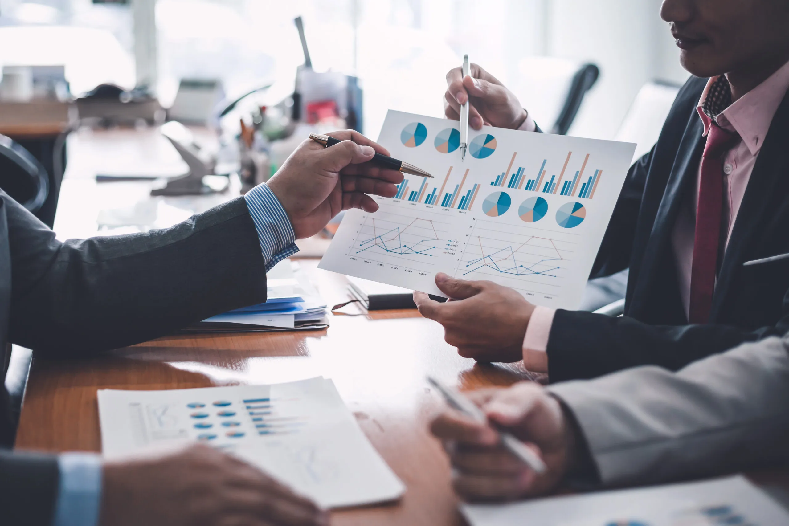 people reviewing investment documents and financial reports