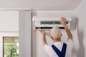 Technician maintenance air conditioning open ac unit to checking filters in a living space. Service includes cleaning, replacement elements, ensuring optimal cooling and heating performance indoors, austin landlord-tenant law​