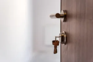 The keys in the lock of the door. Safety and privacy concept.