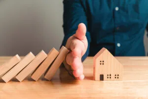 Austin Texas Tenant Rights: Everything You Need to Know, Home insurance and safety with hand protect house idea with people background. Hand covering wooden property and residence model from risk disaster and problem. After sales service representation.