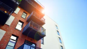 Modern multifamily building in a european city. Walls made of concrete. Luxury house complex, How to Invest in Multifamily Real Estate