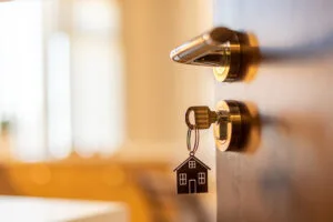 Open door to a new home. Door handle with key and home shaped, Is Texas landlord friendly for entry rights | | Bay Management Group Texas