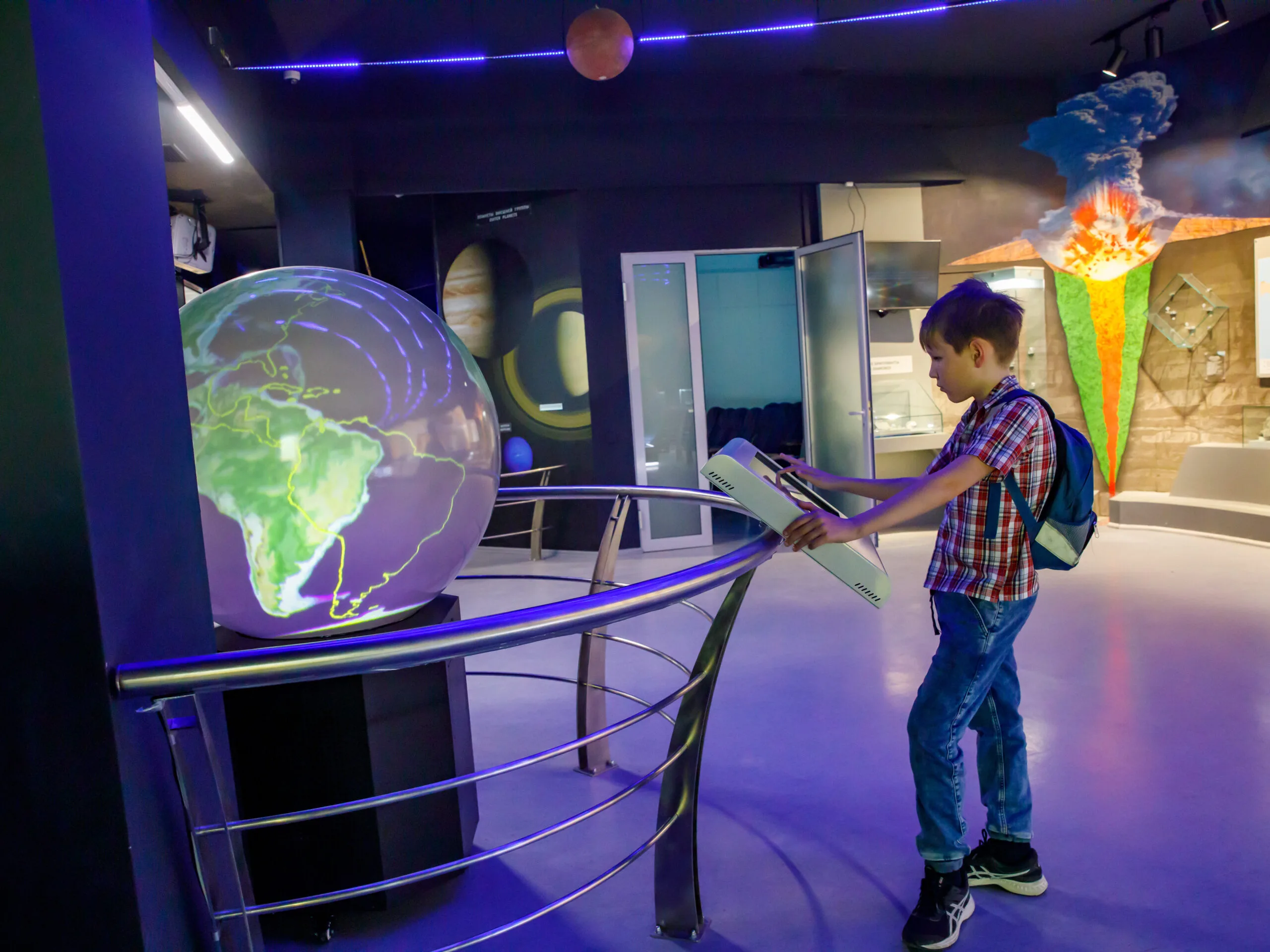 Yong school boy enjoy play and learn with science learning activities at the space and Earth evolution museum | Bay Prop