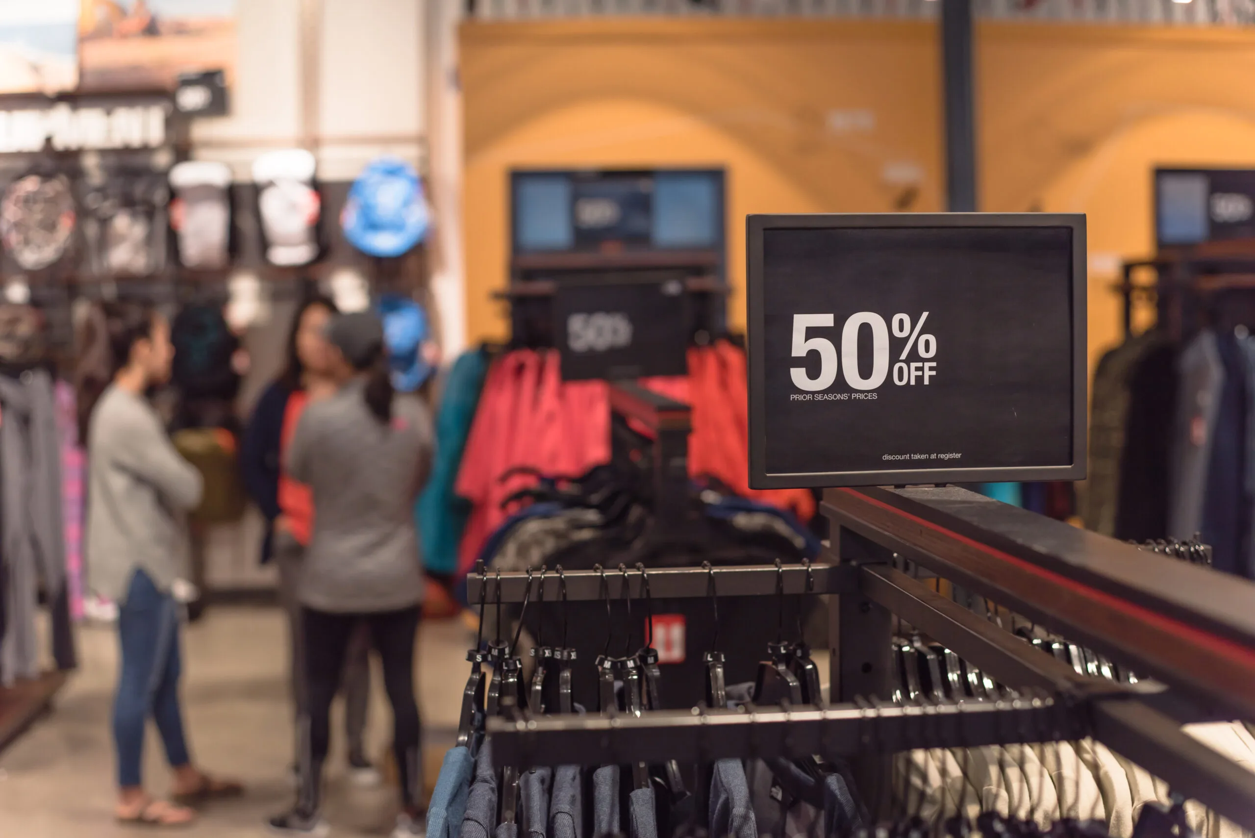 Close-up red tag sale 50 percent discount and customer shopping at outdoor department store in Texas, America. Big reduc